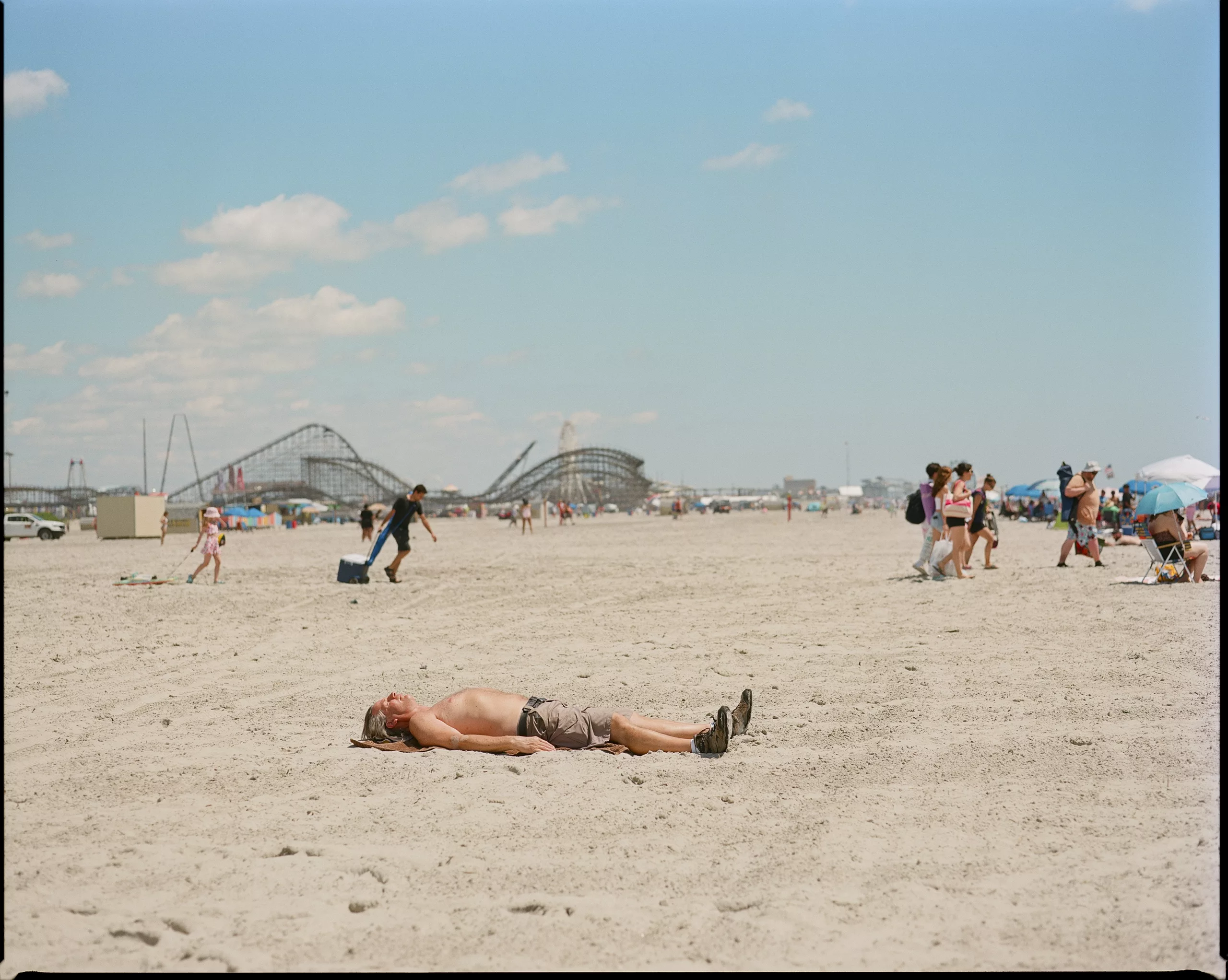 6x7 beach scene with a sunbather and roller coasters, Mamiya RZ67, Portra 400