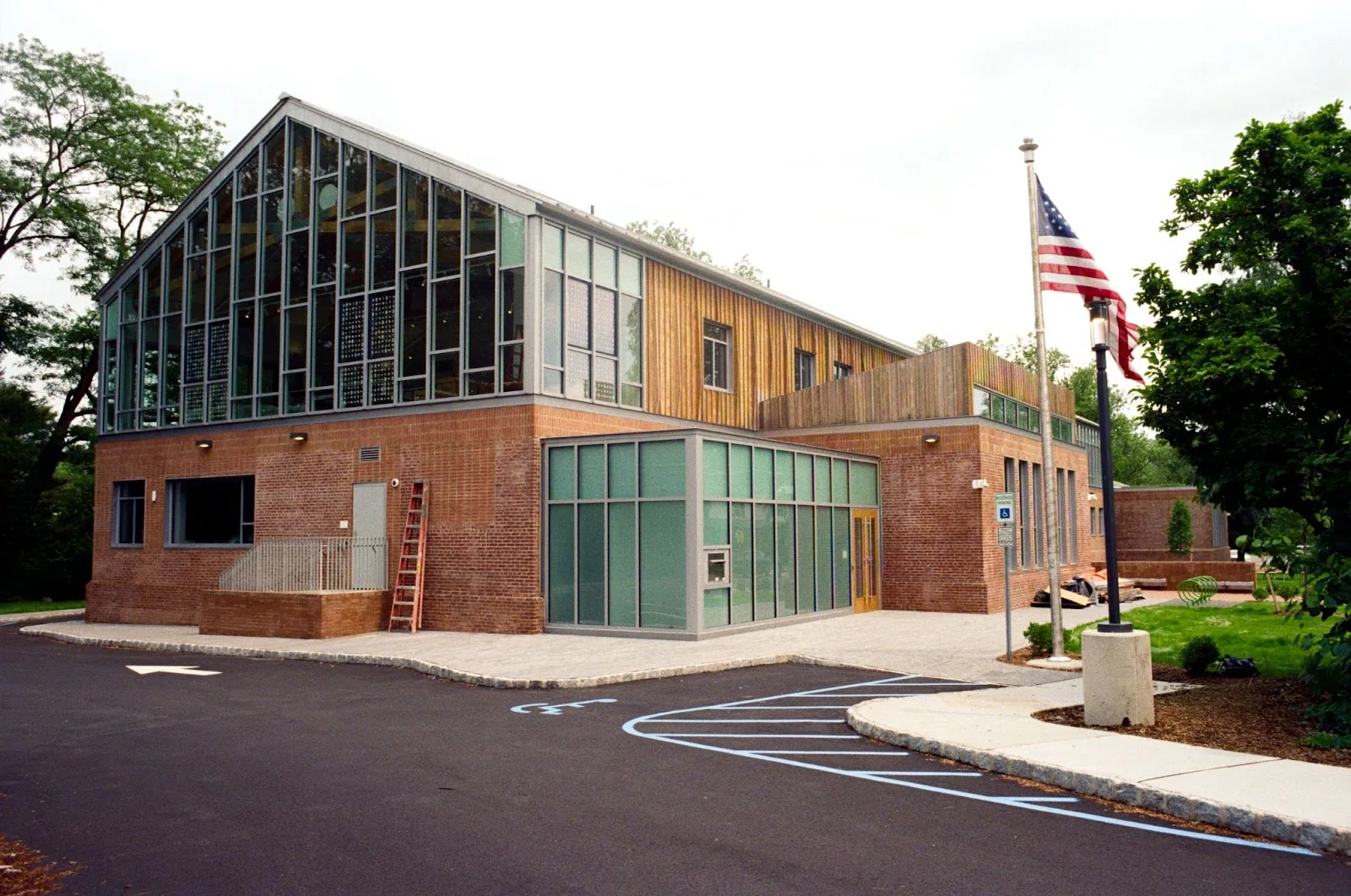 The rebuilt Maplewood Memorial Library, brick with a tall glass gable, flag out front