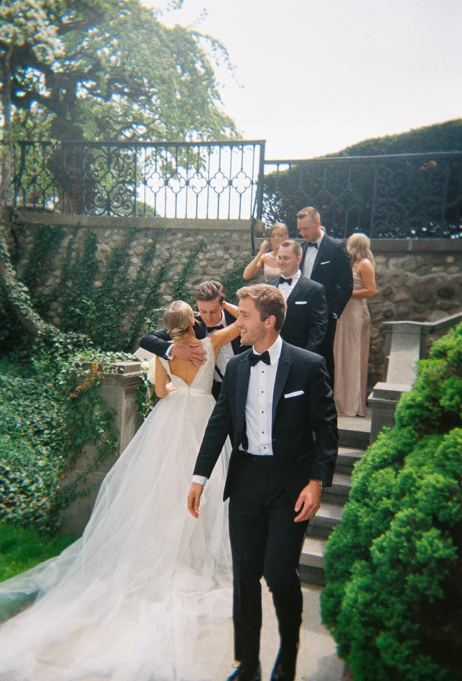 A wedding party on garden steps, shot on a Cheecam disposable