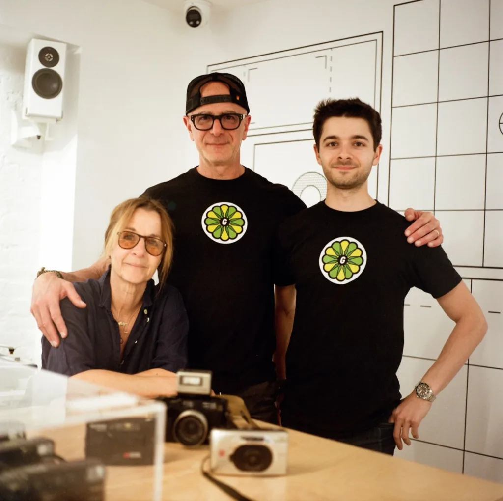 The Krueger family behind the counter at Gelatin Labs, with film cameras on the counter